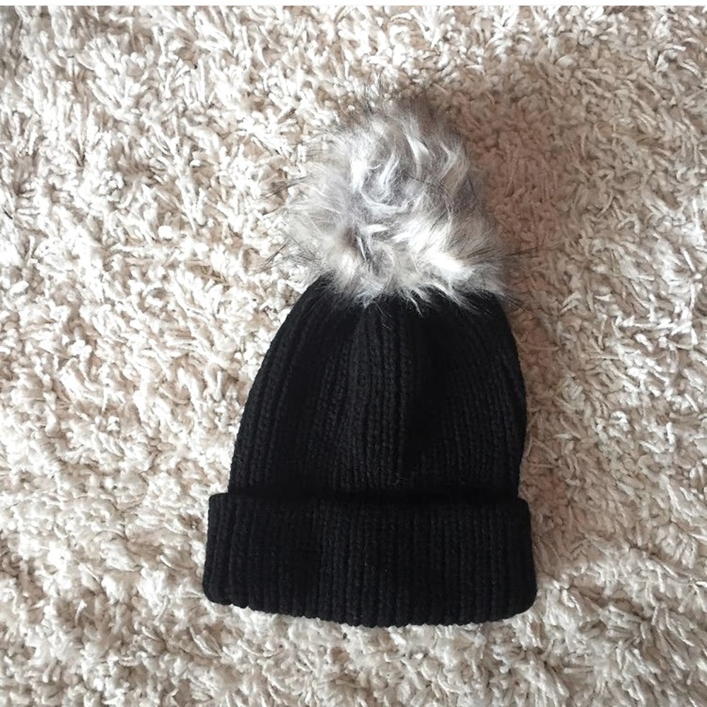 Black winter hat with puff ball on top